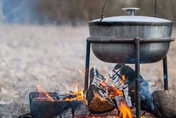 pot on fire close-up, cooking on an open fire during a hike,