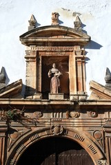 Statue detail above the side door of the San Francisco church (Iglesia San Francisco) in the Plaza de Espana, Ecija, Spain.