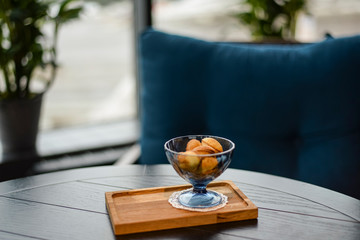 Russian walnut cookies stuffed with condensed milk in glass bowl in a restaurant with blurred background.