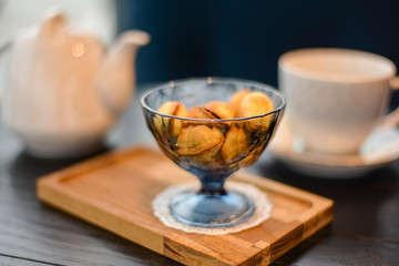 Russian walnut cookies stuffed with condensed milk in glass bowl in a restaurant with blurred background.