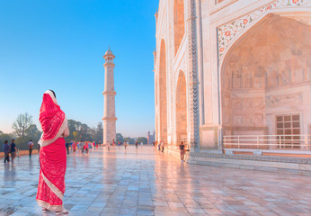 Taj Mahal, Agra, India - Young woman in traditional red clothes