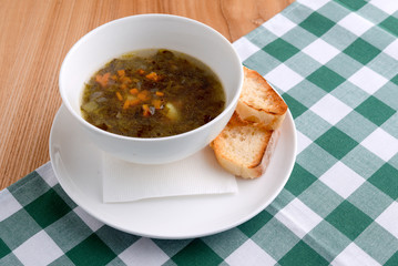 Traditional Ukrainian soup with meat and vegetables and macaroni. Ukrainian cuisine, healthy soup in a bowl.