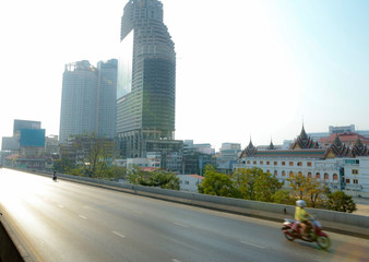 Bangkok, THAILAND - February 24, 2020: In the morning many car and motorcycle is running from Saphan Taksin Station and cross the bridge in bangkok.