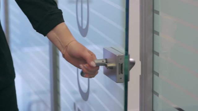 Woman opens the door to man businessman in the office closeup slow motion