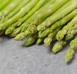 Asparagus. Fresh Green Asparagus on grey background. Selective focus. 