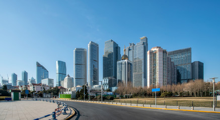 Qingdao urban skyline and asphalt road architectural landscape..