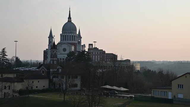 Colle Don Bosco, Piedmont, Italy. March 2020. View on the imposing basilica. Tilt movement footage. At the base of the basilica is the house where the saint lived. Late afternoon light.