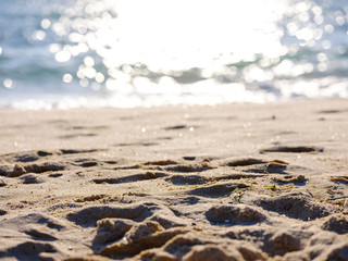 Footprints of feet on the beach at the sea