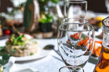 Glasses in the foreground. Table set for dinner in the restaurant