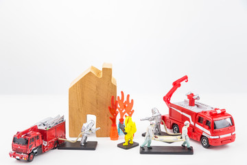 Toys staff are fighting fire, house fires and rescue house models isolated on a white background.