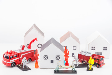 Toys staff are fighting fire, house fires and rescue house models isolated on a white background.