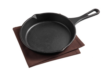 Empty iron pan and napkin isolated on white background