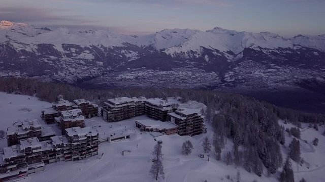 Beautiful Sunrise Scenery Over The Snow Filled Thyon Ski Resort In Switzerland On A Cold Winter Morning - Aerial Shot