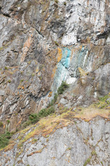 A colorful mountain view of a zodiac boat in Tofino
