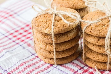 oatmeal cookies in a paper bag on burlap. Concept photo - vegetable food, eco-friendly packaging and natural background