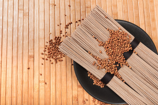 Buckwheat noodles closeup. Raw food ingredient. Dried buckwheat soba noodles. Traditional Japanese food - Image