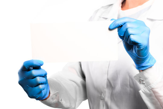 Doctor hand in sterile gloves holding card with text palce   isolated on white background - Image