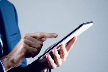 businessman holds tablet in hand