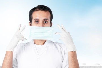 Asian doctor man in protective gloves wearing flu