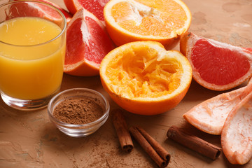 Organic foods orange, grapefruit, juice and aromatic cinnamon. Brown background.