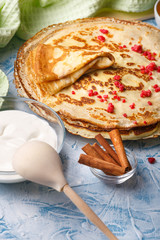 Delicious Russian pancakes with sour cream and honey cooked for Shrovetide celebration