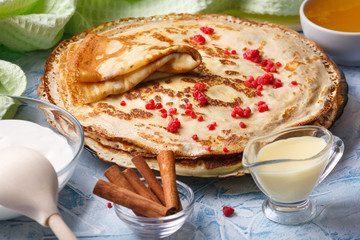 Delicious Russian pancakes with sour cream and honey cooked for Shrovetide celebration