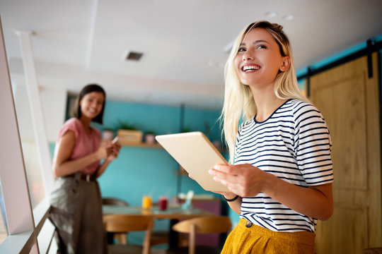 Portrait of smiling woman in office with tablet