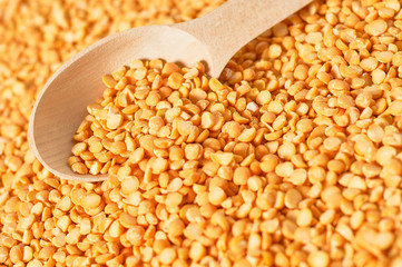 Rustic wooden spoon and grain of peas. Copy space