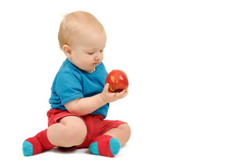 Fototapeta na wymiar Baby boy with an apple on white background