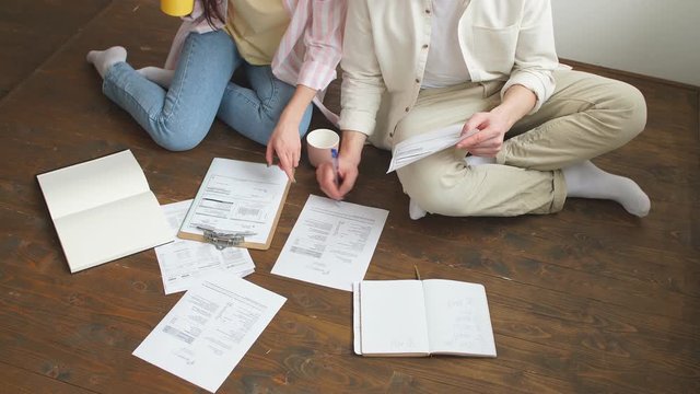 Young people working with paper, document. Family developing business. Couple managing their badget.