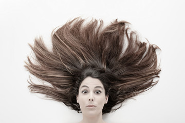 expressive woman's head with long hair on a white background