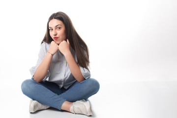 expressive sitting girl on a white background