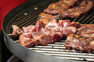 Fresh grilled meat. Street food background. Grilled pork ribs on the grill. Marinated pork spare ribs. Street market. Food catering, party.