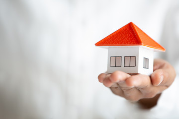 Orange roof houses in the hands of investors, real estate investment ideas, saving and buying houses, mortgages and bank loans Renting and buying a home.