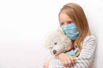 Coronavirus covid-19 and pollution protection concept. little child girl hugging teddy bear doll with wearing mask to against corona virus and air pollution pm2.5 on white background
