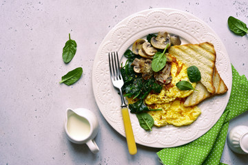 Omelet with spinach and fried mushroom. Top view with copy space.