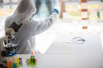 The doctor is testing a sample of biological tubes contaminated by Corona-virus Covid 19 and searching for a vaccine against the virus. In the laboratory and film samples of infected lung