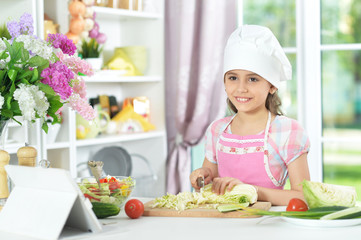 Portrait of cute girl preparing delicious fresh salad