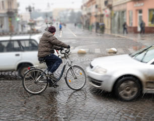 Dangerous city traffic situation with cyclist and car in the city