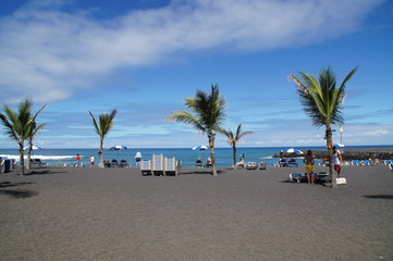 picturesque Playa Jardín beach on the Spanish Canary Island Tenerife with black volcanic sand blue...