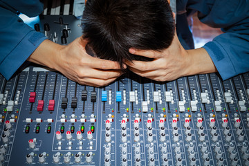 asian male music producer, dj, sound engineer feel disappointed at bad sound in studio. music...