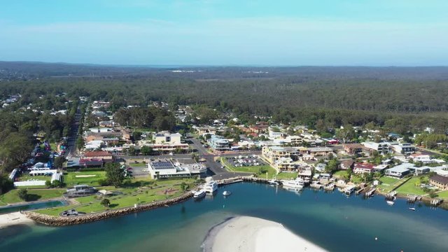 Aerial drone view of Huskisson on the New South Wales South Coast, Australia, showing Currambene Creek and Jervis Bay on a bright sunny day   