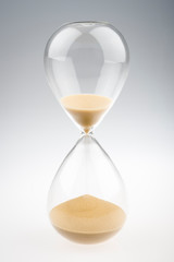 Shiny modern hourglass with golden brown sands running down on gradated white background