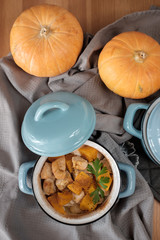 Pumpkin roast in a blue pan on a wooden table