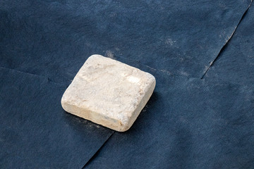 Overlapping of laid woven geotextile fabrics temporarily pressed with a paver in the summer garden under reconstruction