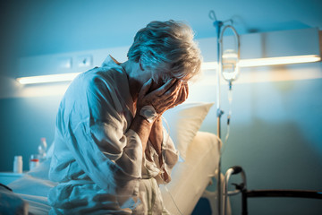 Lonely senior patient crying at the hospital