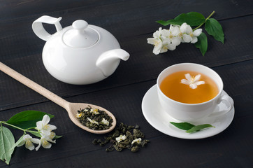 Green tea with jasmine in cup and teapot