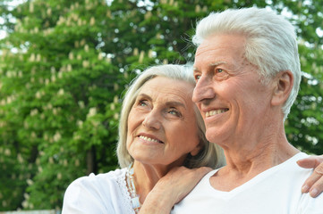 Close up portrait of beautiful senior couple hugging in the park