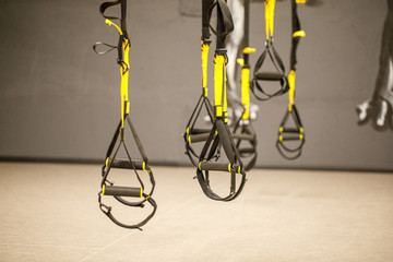 Straps training loop equipment. Black functional training equipment on grey background. Sport accessories. Fitness and Gym workout items for Healthy. Trx fitness straps for working with own weight.