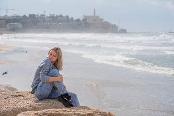 Fantastic view of a girl on Israel sea. Winter daylight view. Copy space